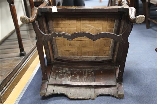 An 18th century boarded oak framed armchair,